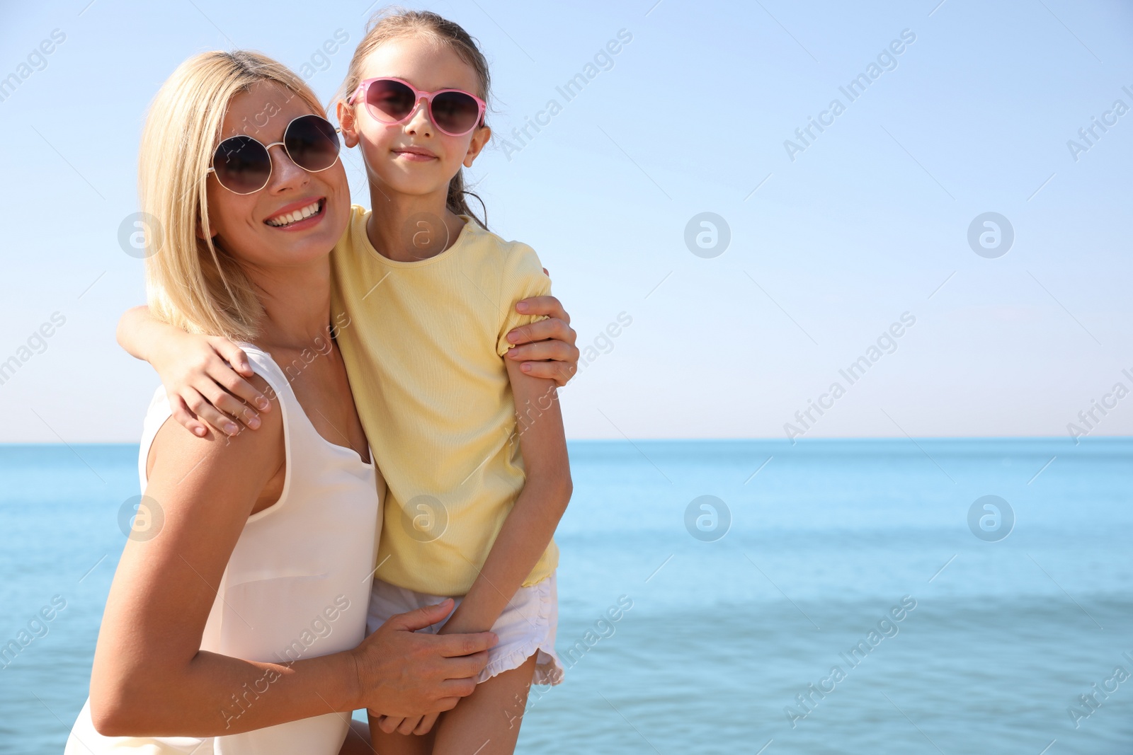 Photo of Mother and daughter at beach. Family vacation