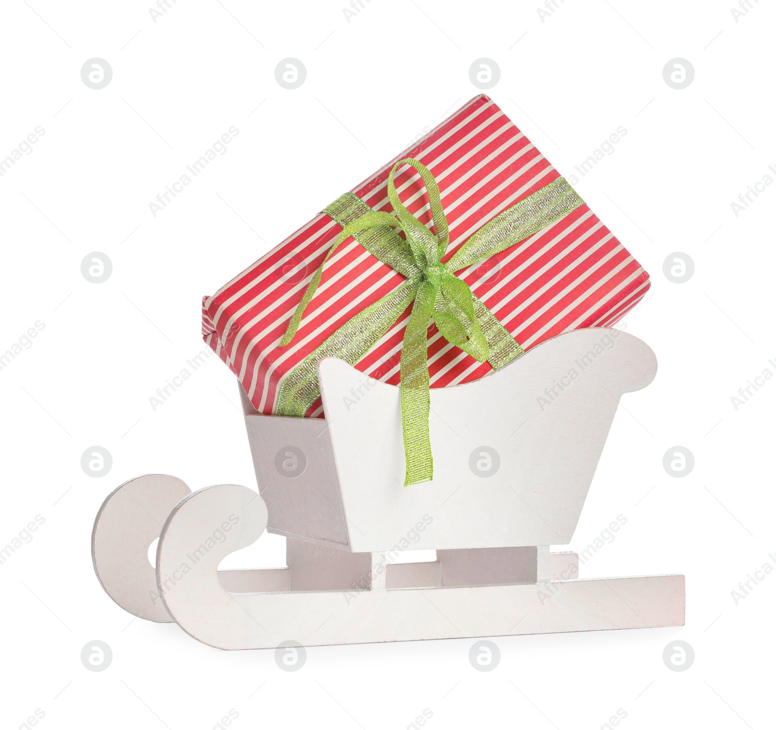 Photo of Wooden sleigh with Christmas gift box on white background