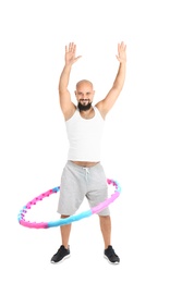 Overweight man with hula hoop on white background