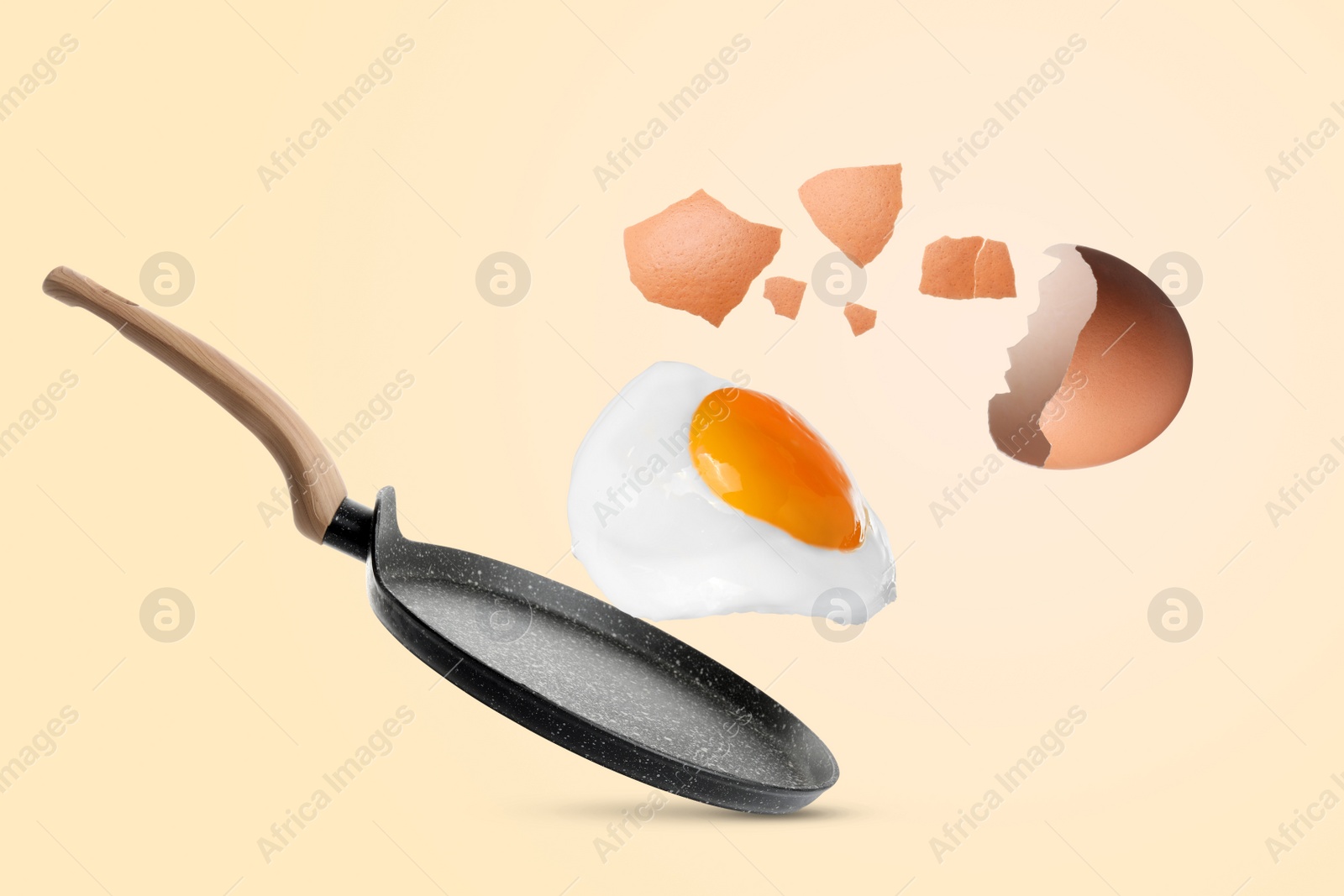 Image of Tasty fried chicken egg with shell falling into frying pan on color background