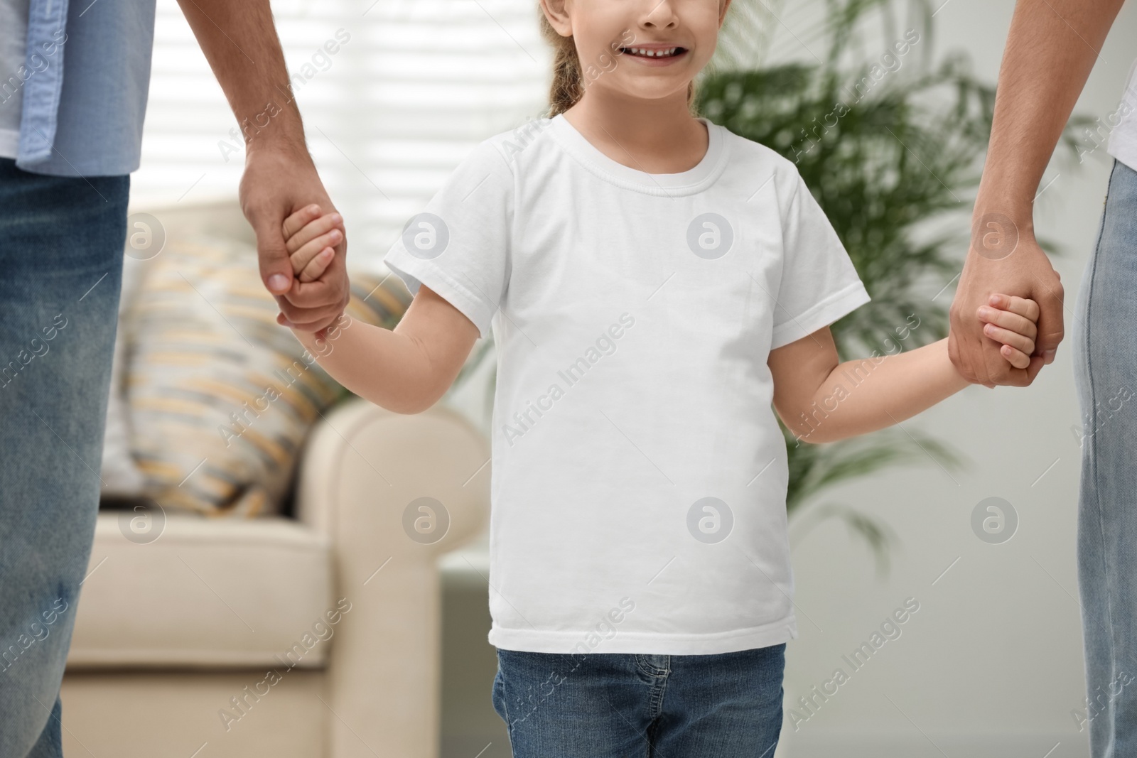 Photo of Happy family holding hands indoors, closeup view