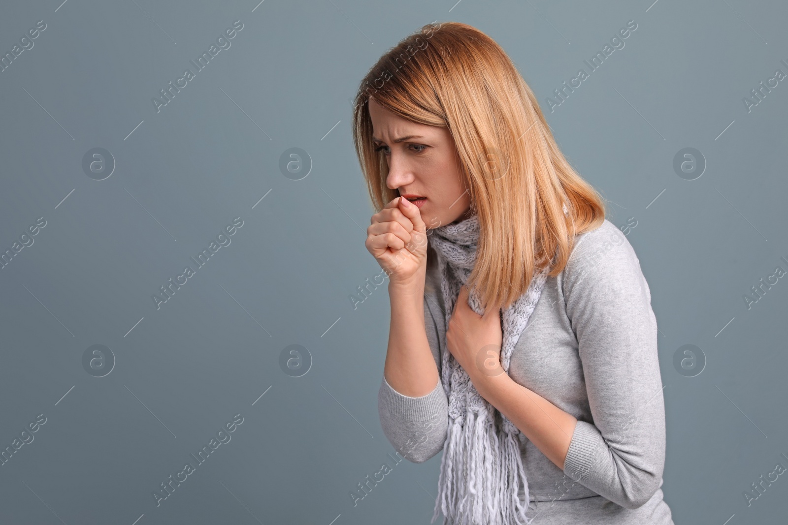 Photo of Young woman coughing on color background