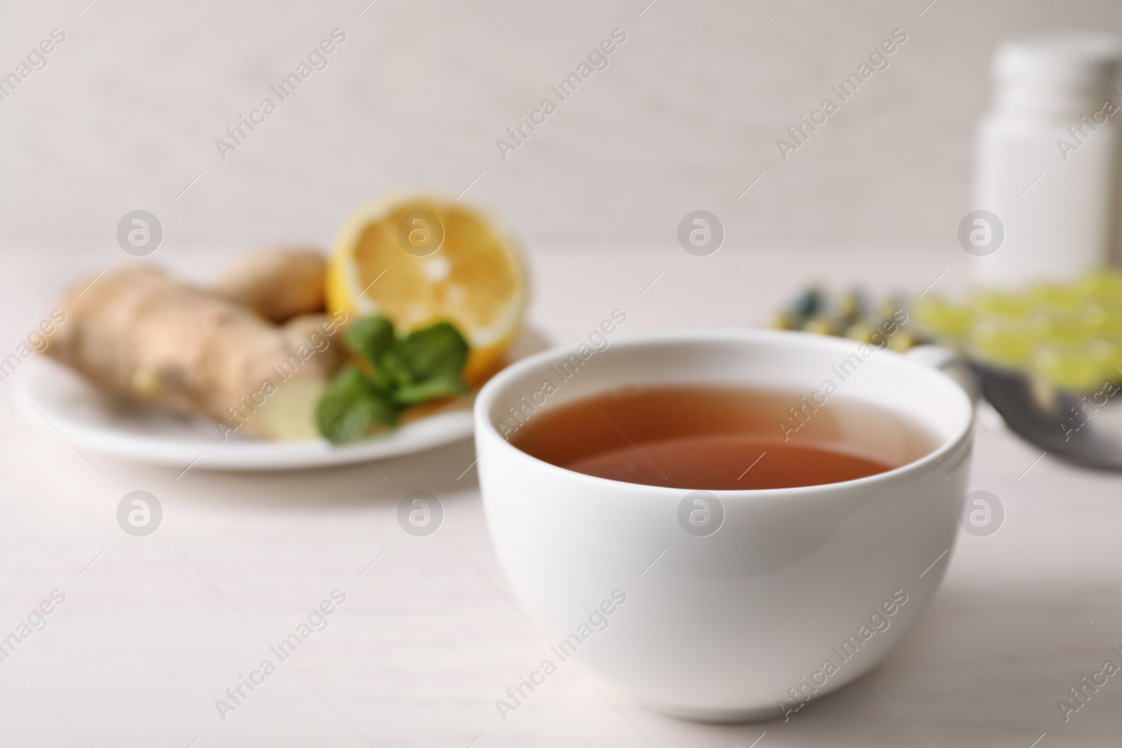Photo of Cup of hot tea on table, space for text. Cough remedy