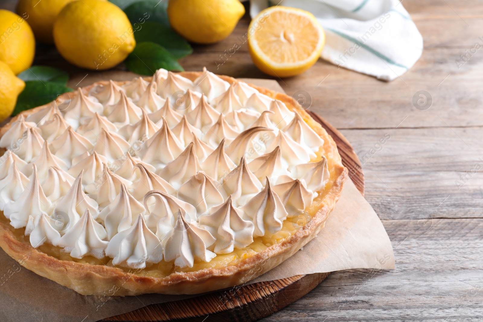 Photo of Delicious lemon meringue pie on wooden table