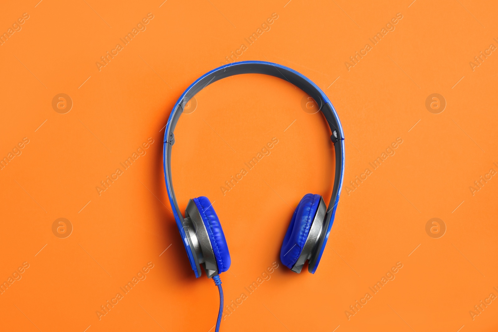 Photo of Stylish headphones on color background, top view