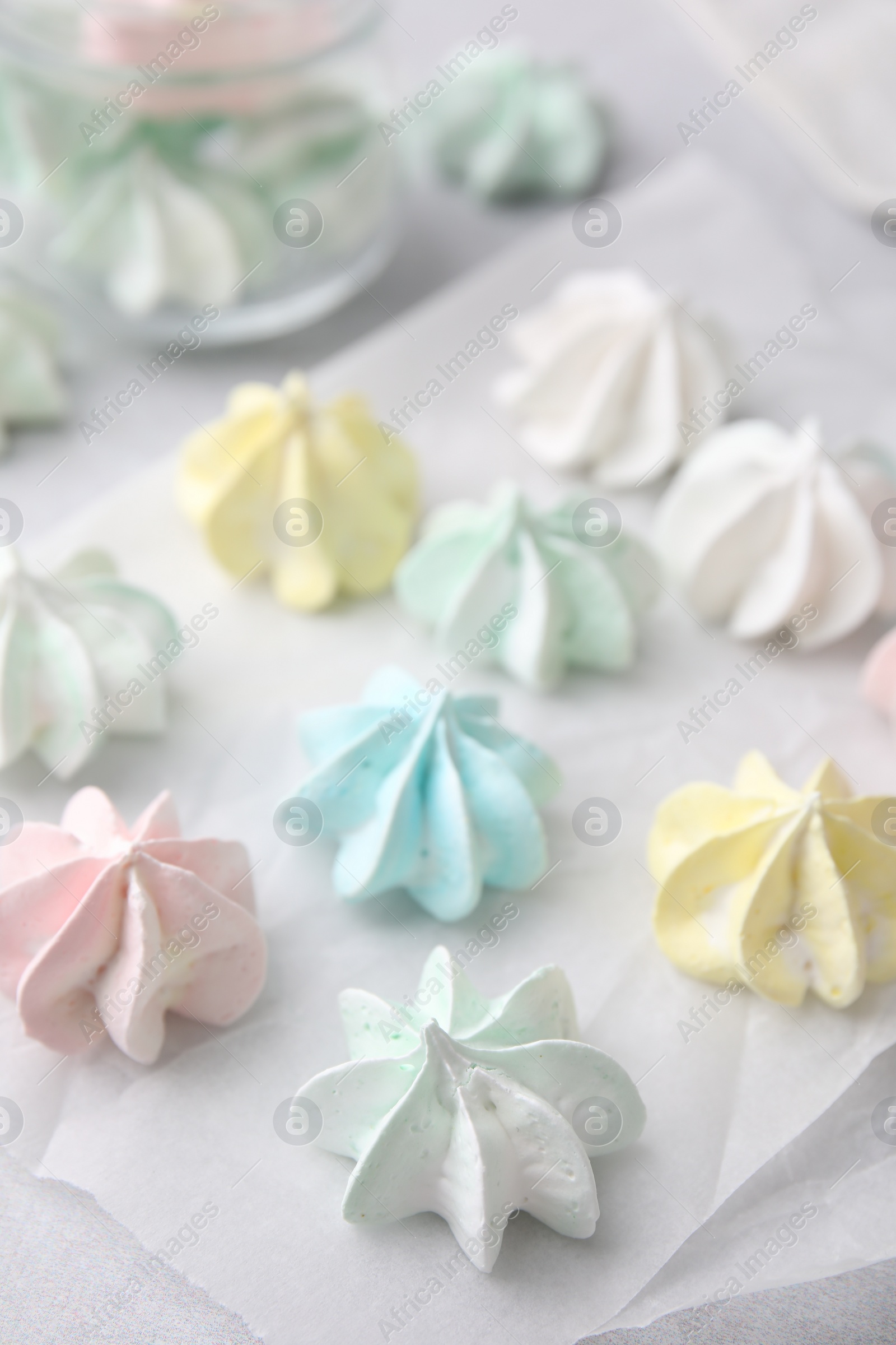 Photo of Tasty meringue cookies on light grey table, closeup