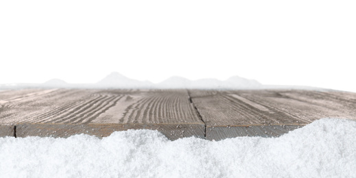 Photo of Heap of snow near wooden surface isolated on white