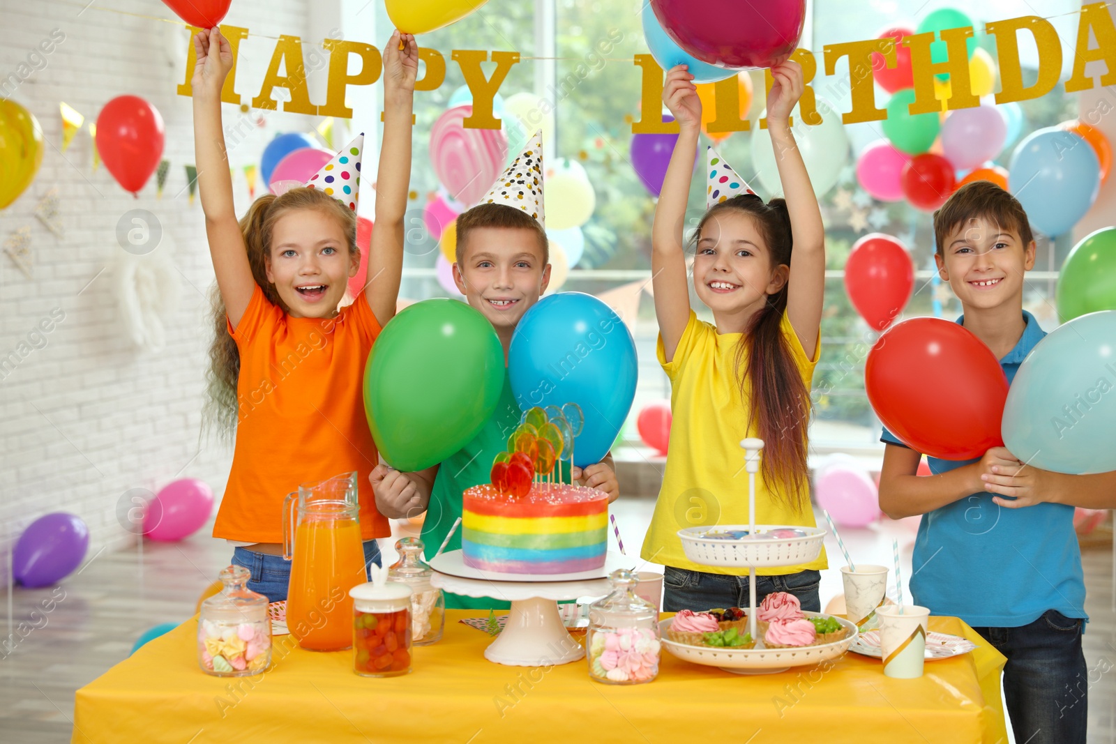 Photo of Happy children at birthday party in decorated room