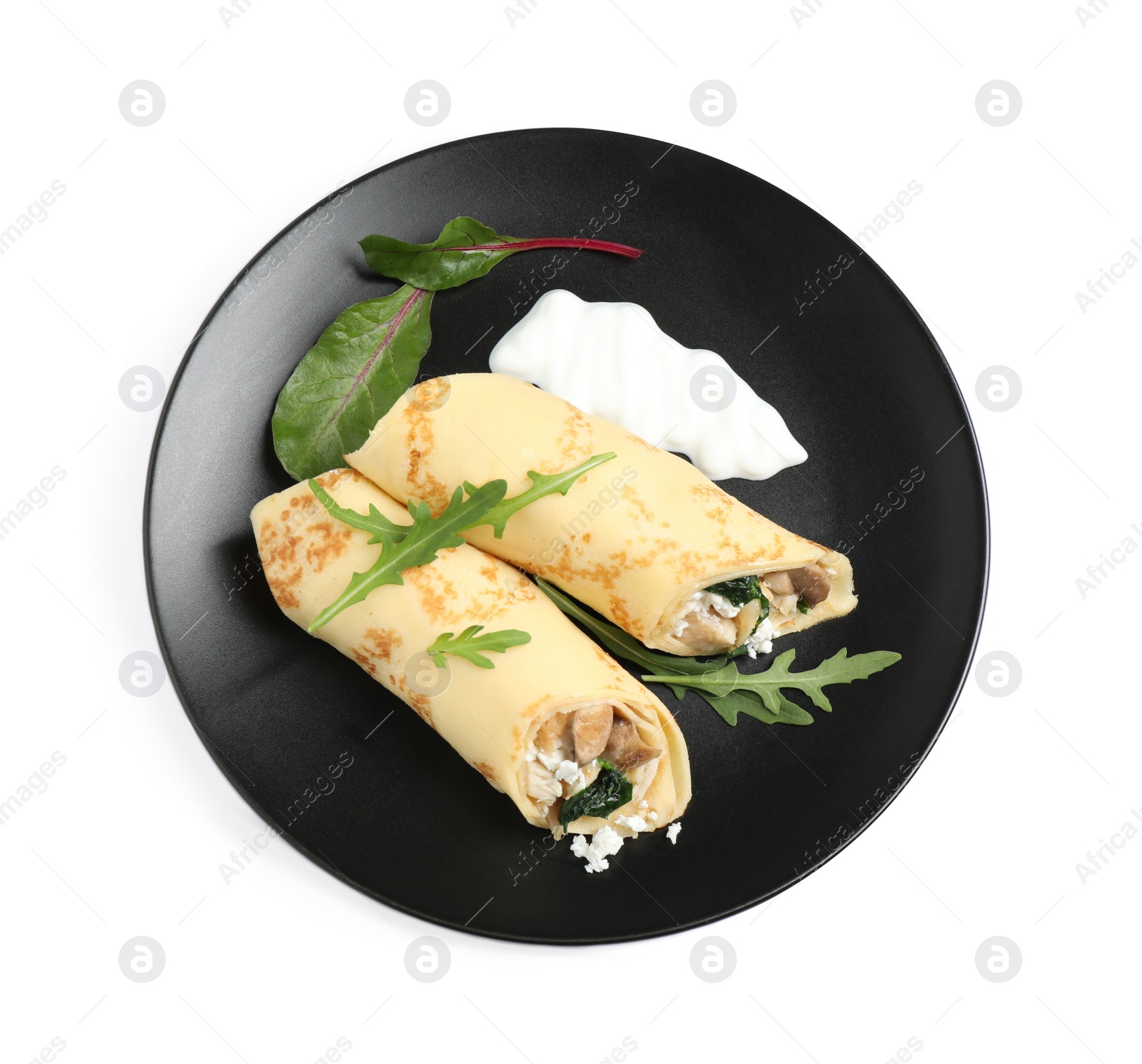 Photo of Delicious thin pancakes with chicken and mushrooms isolated on white, top view