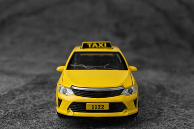 Yellow taxi car model on grey background