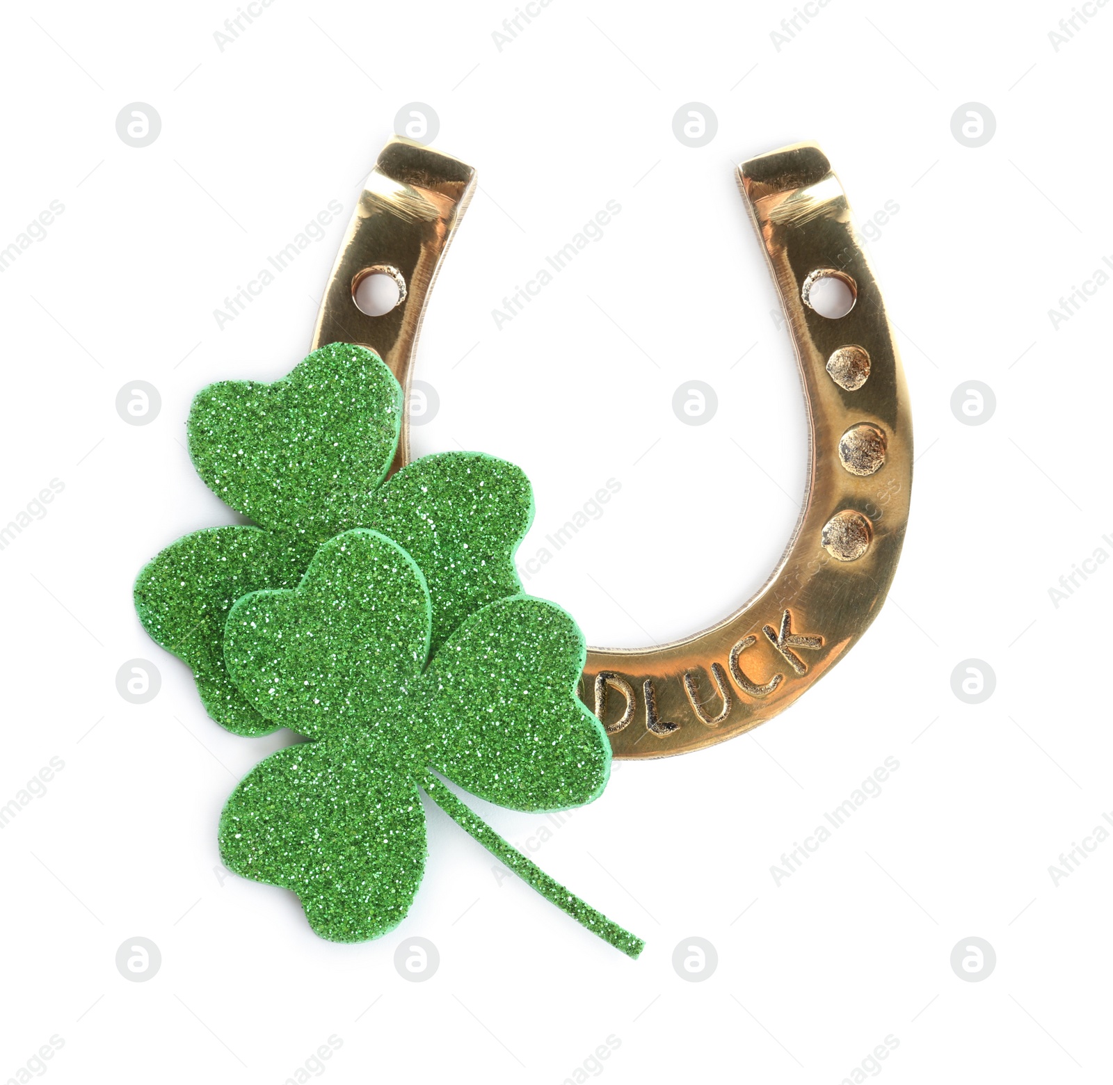 Photo of Golden horseshoe and decorative clover leaves on white background, top view. Saint Patrick's Day celebration