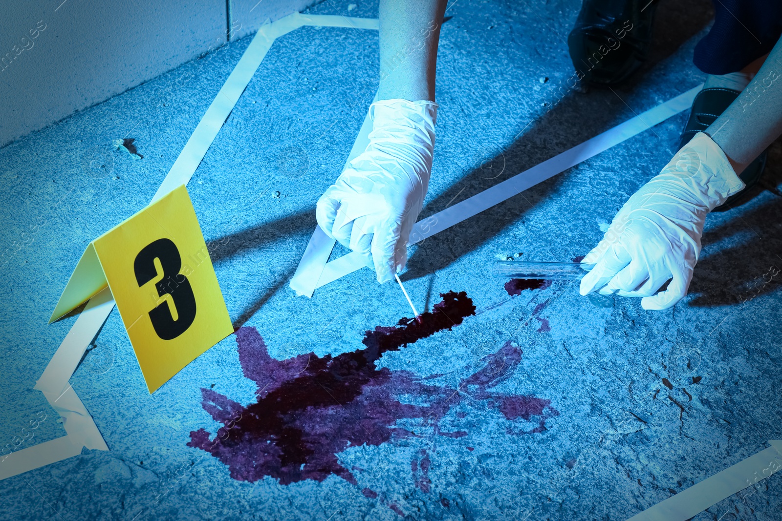 Photo of Detective collecting evidences at crime scene, closeup