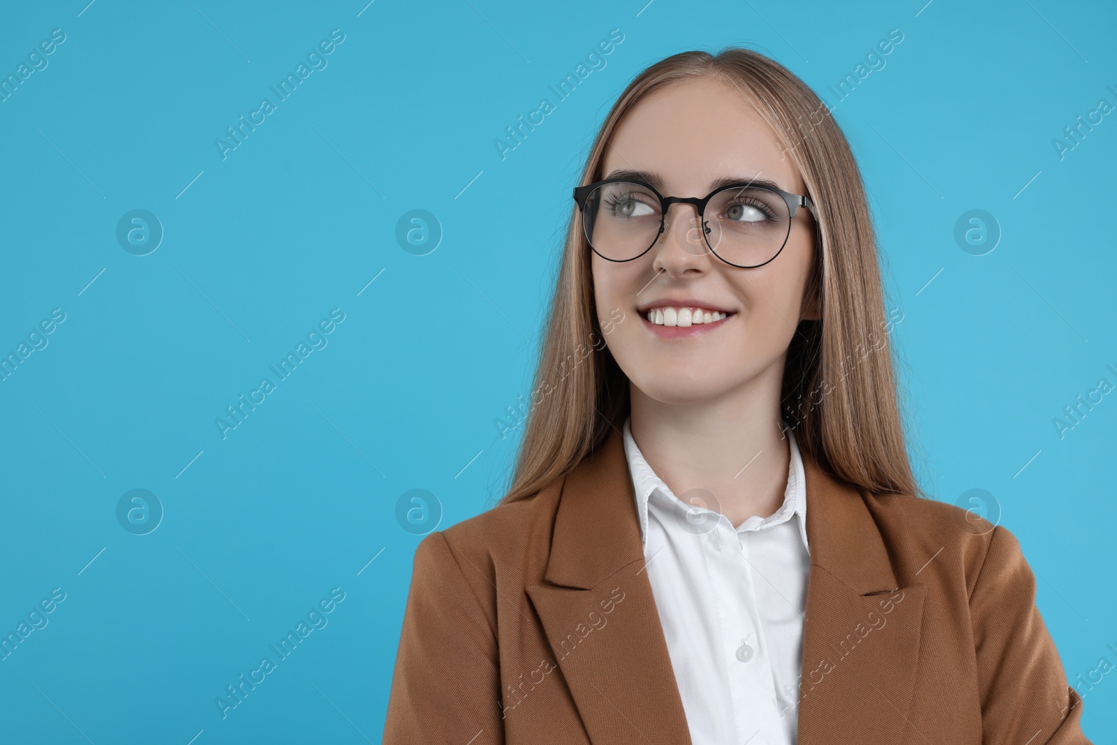 Photo of Portrait of happy young secretary on light blue background, space for text