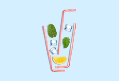 Creative lemonade layout with lemon slice, mint, ice cubes and straws on turquoise background, top view