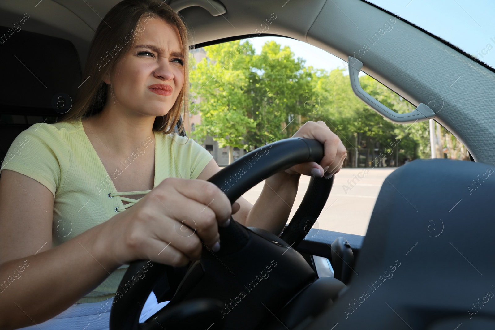 Photo of Emotional woman in car. Aggressive driving behavior