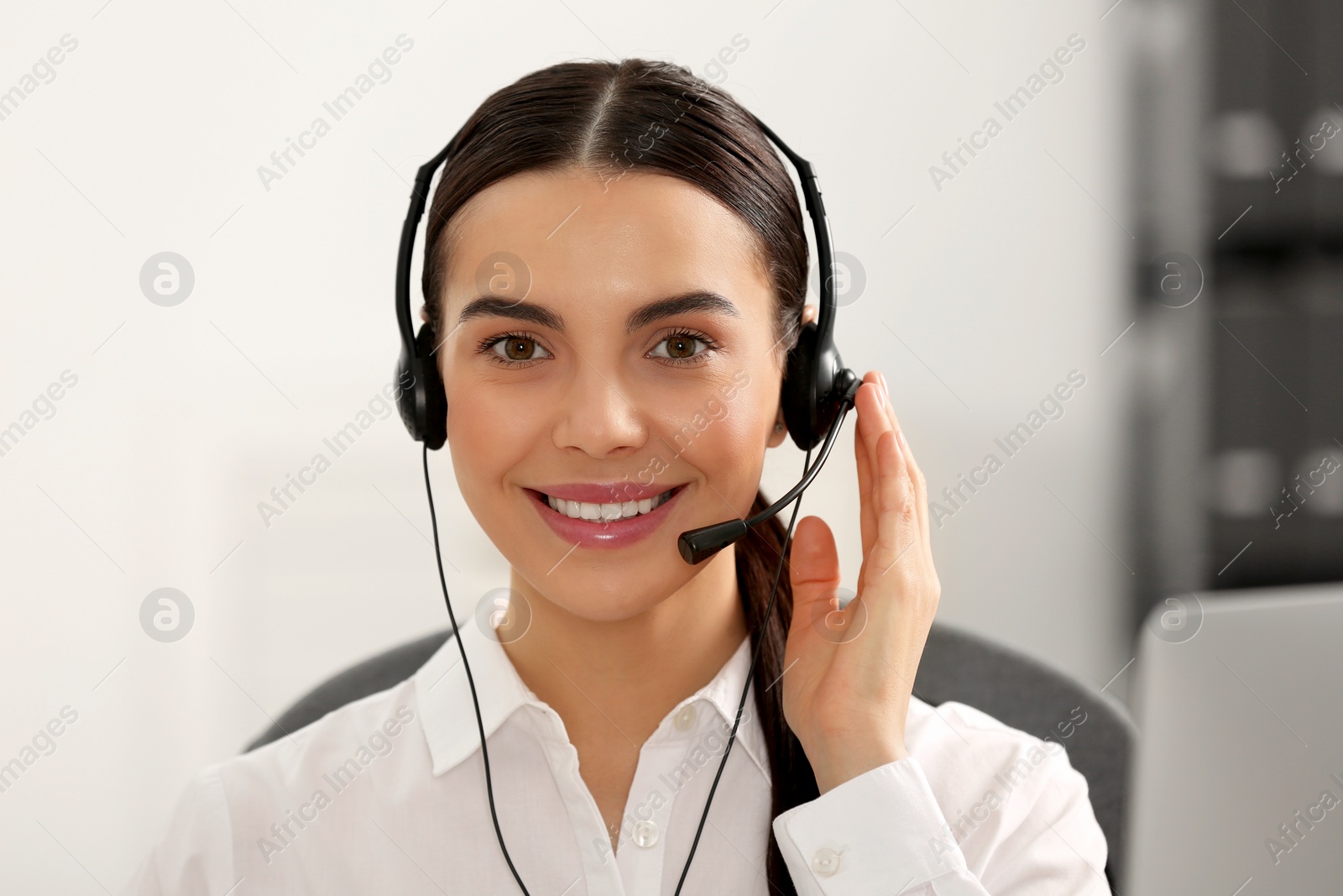 Photo of Hotline operator with headset working in office