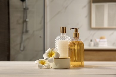 Photo of Composition with liquid soap in glass dispenser on white wooden table indoors