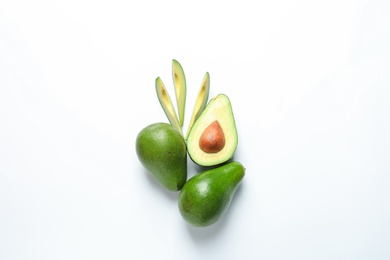 Composition with ripe fresh avocados on white background