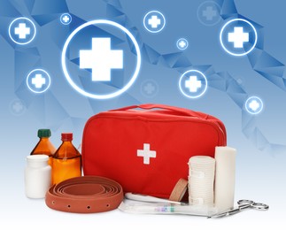 First aid kit and illustrations of cross symbols on blue background, closeup