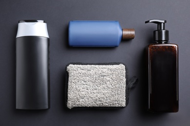 Flat lay composition with men's cosmetic products on black background