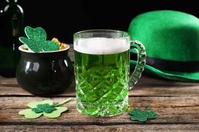 St. Patrick's day party. Green beer, leprechaun hat, pot of gold and decorative clover leaves on wooden table