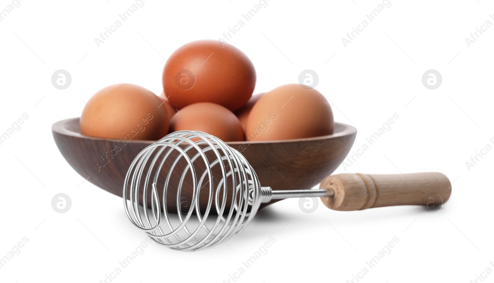 Photo of Whisk and bowl with raw eggs isolated on white