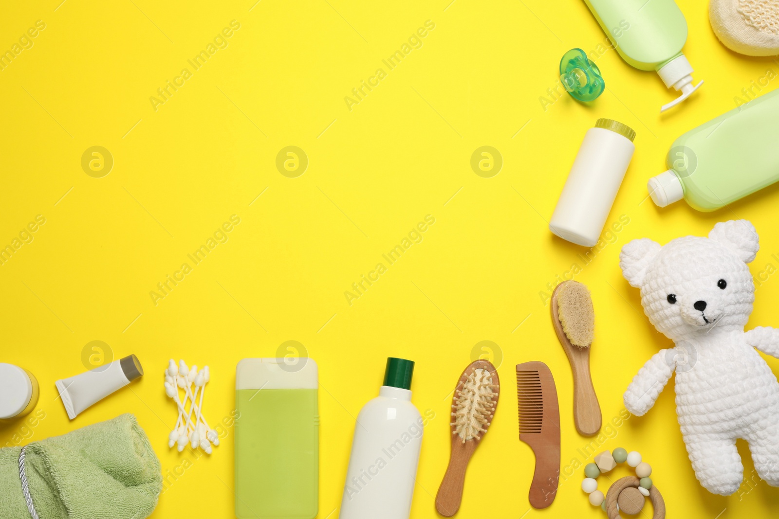 Photo of Flat lay composition with baby cosmetic products on yellow background, space for text