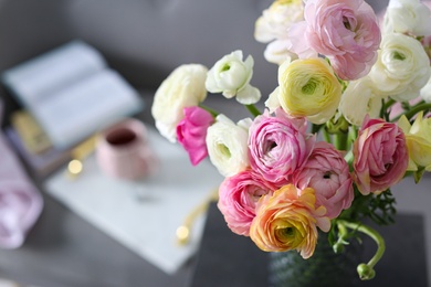 Photo of Bouquet of beautiful ranunculuses in living room. Space for text