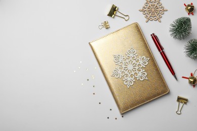 Photo of Stylish planner and Christmas decor on white background, flat lay with space for text. New Year aims