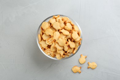 Delicious goldfish crackers in bowl on grey table