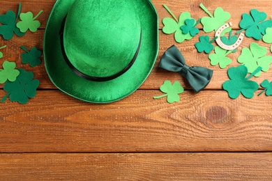 Leprechaun's hat and St. Patrick's day decor on wooden background, flat lay. Space for text