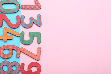 Wooden numbers on colorful background, flat lay. Space for text
