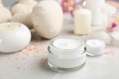 Photo of Beautiful spa composition with skin care products and candles on marble table, closeup