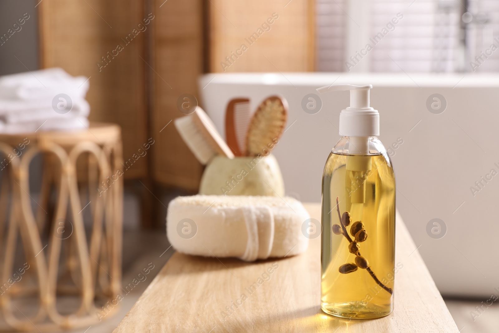 Photo of Dispenser with liquid soap on wooden table in bathroom, space for text