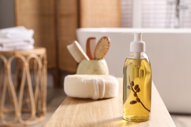 Photo of Dispenser with liquid soap on wooden table in bathroom, space for text