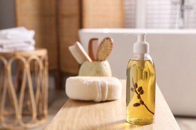 Dispenser with liquid soap on wooden table in bathroom, space for text