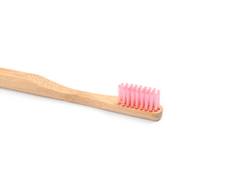Bamboo toothbrush with pink bristle isolated on white