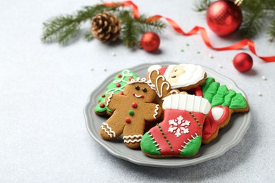 Tasty homemade Christmas cookies on light grey table. Space for text