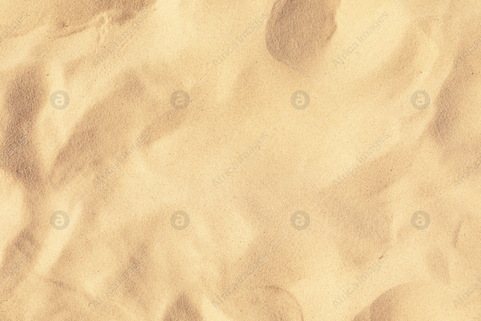 Photo of Golden beach sand on sunny day as background