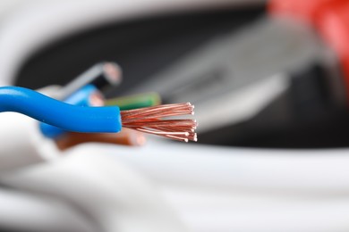 Photo of One new colorful electrical wire on blurred background, closeup view