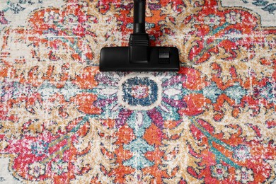 Photo of Removing dirt from carpet with modern vacuum cleaner. Space for text