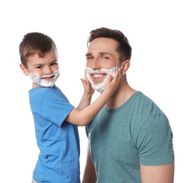 Photo of Happy dad and son with shaving foam on faces against white background