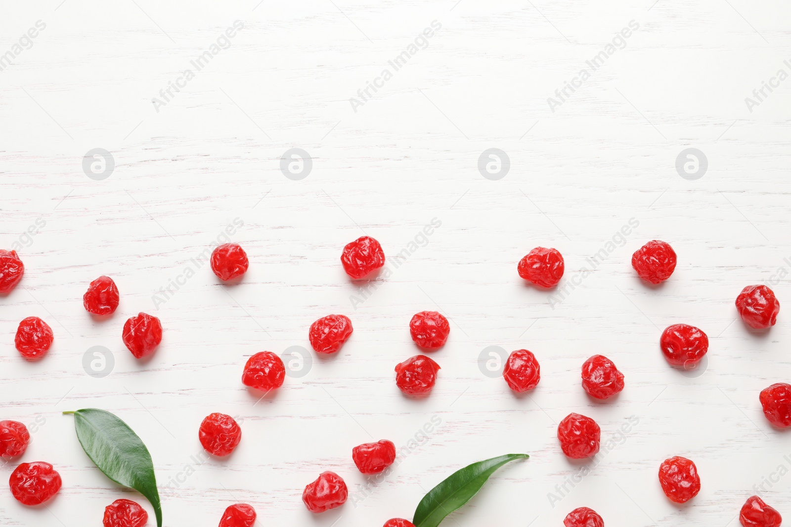 Photo of Tasty cherries on wooden background, flat lay with space for text. Dried fruits as healthy food