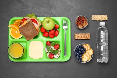 Photo of Flat lay composition with serving tray, tasty healthy food and bottle on grey table. School dinner