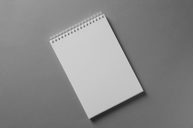 Blank notebook on light grey background, top view. Mockup for design