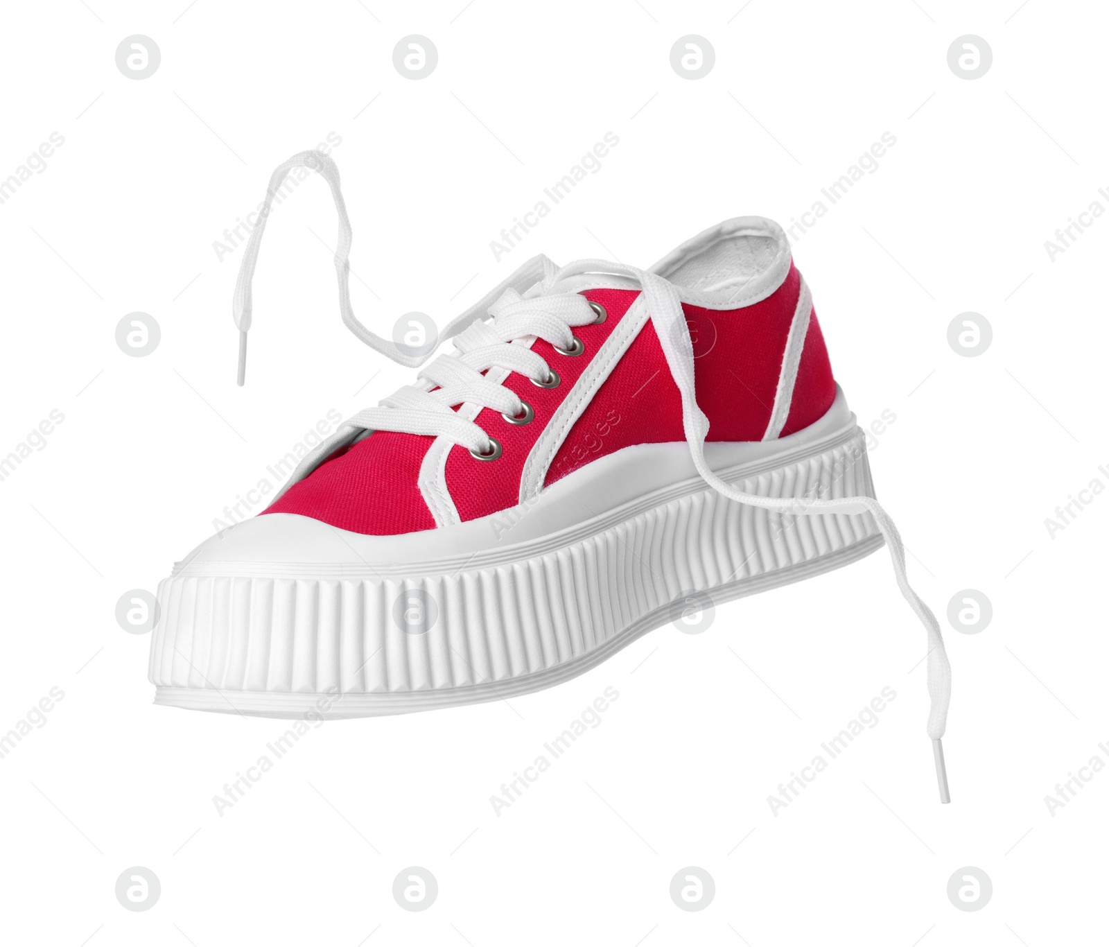 Photo of Red classic old school sneaker isolated on white