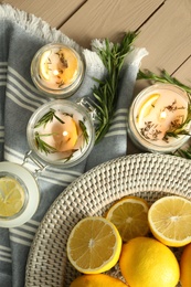 Photo of Flat lay composition with natural homemade mosquito repellent candles on wooden table