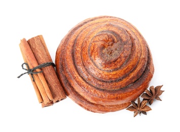 Photo of Freshly baked cinnamon roll with ingredients on white background, top view