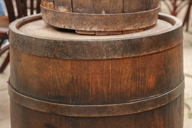 Photo of Traditional wooden barrels outdoors, closeup. Wine making