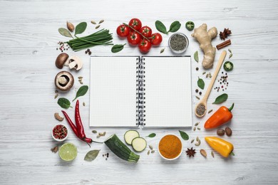 Photo of Open recipe book and different ingredients on white wooden table, flat lay. Space for text